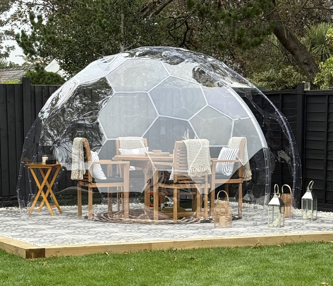 A GeoDomeX dome set up for dining on a paved base